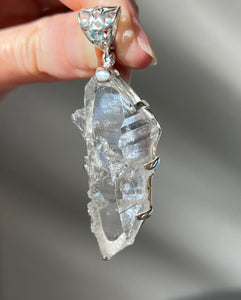 Luminous Arkansas Quartz with bridge formation and Blue Topaz pendant