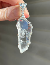 Load image into Gallery viewer, Luminous Arkansas Quartz with bridge formation and Blue Topaz pendant