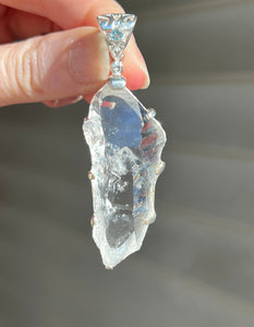 Luminous Arkansas Quartz with bridge formation and Blue Topaz pendant