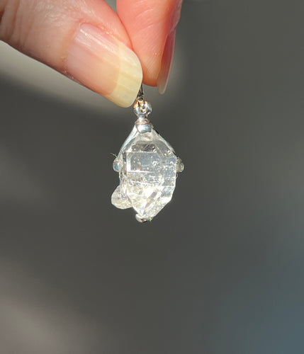 Luminous 11.8 carat Herkimer Diamond pendant with penetrating side car crystal