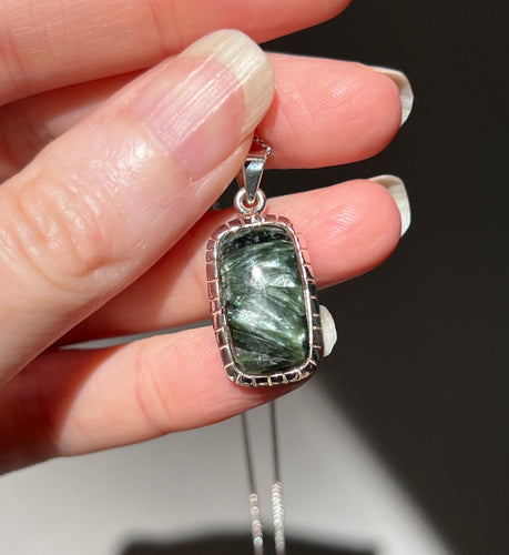 Glistening Seraphinite pendant with detailed silver setting