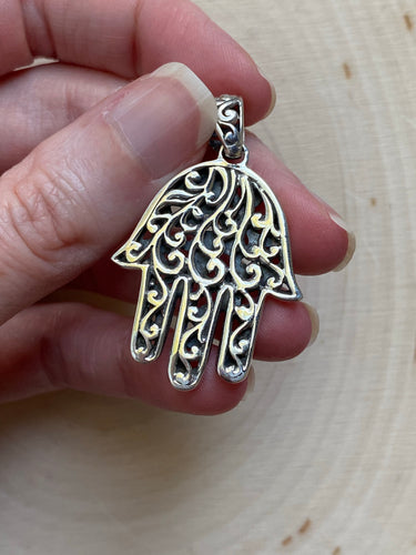 Intricately carved Hamsa pendant